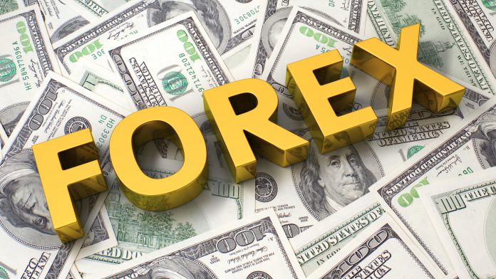 Golden 3D text 'FOREX' displayed on top of a pile of hundred-dollar bills. Learning how to trade Forex is a great path to financial freedom