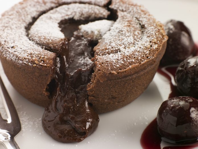 Decadent chocolate lava cake with cherries, showcasing the dessert expertise in a catering side hustle