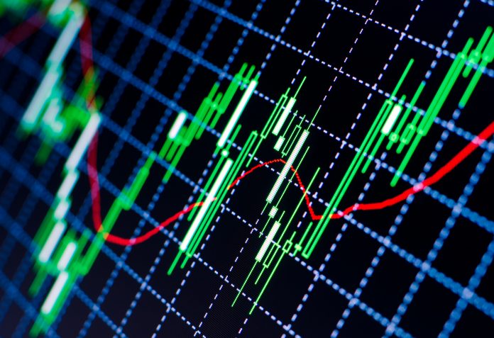 A digital graph showing fluctuating cryptocurrency market trends with green and red candlesticks