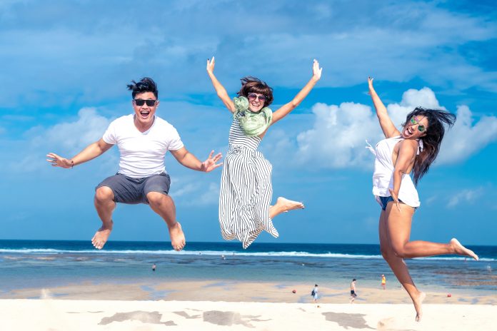 hree people jumping on the beach, celebrating the freedom of starting small business ideas