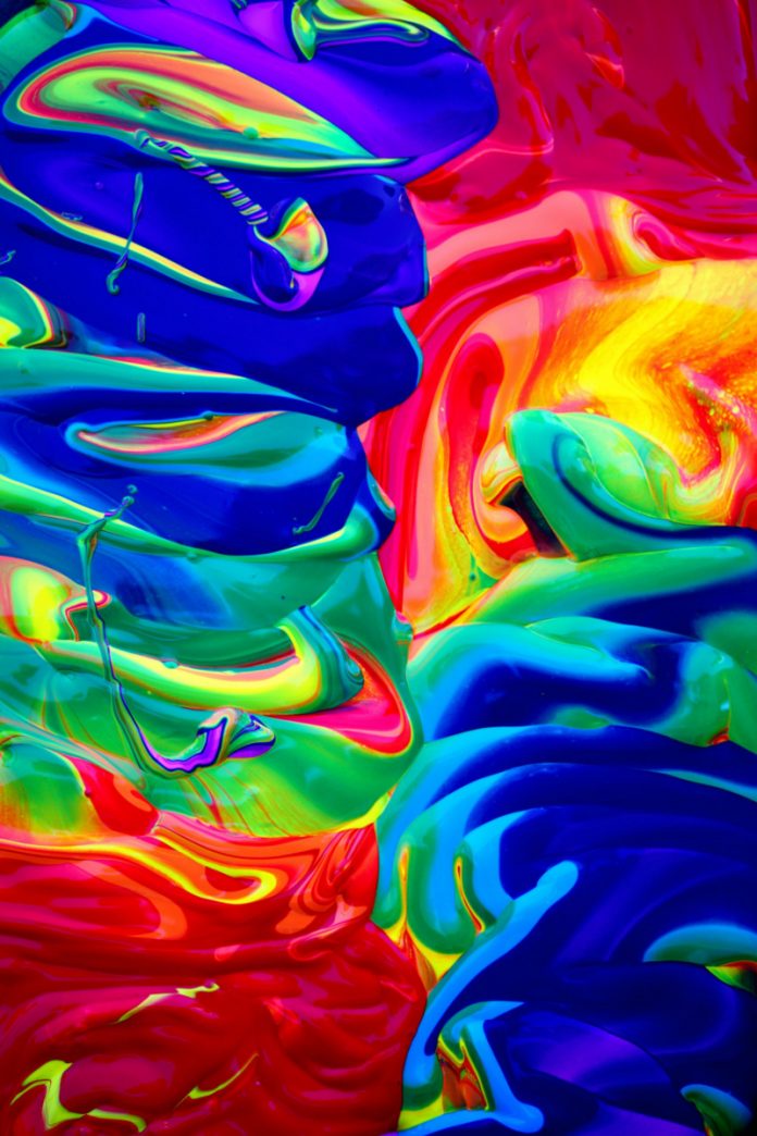 Abstract colourful swirls of paint representing creativity in a graphic design side hustle