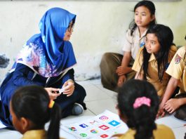 A tutor engaging with students in a classroom setting, representing the start of a freelance tutoring business