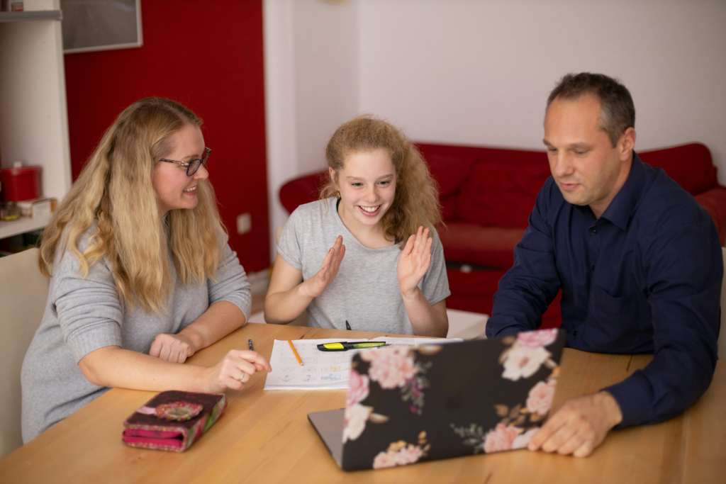 Tutor interacting with a student and parent during an online session, exemplifying successful freelance tutoring