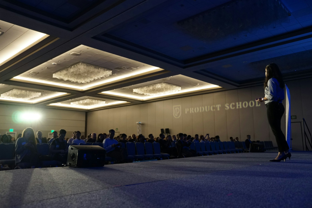 Speaker presenting on stage to an audience, highlighting the importance of effective communication in public speaking