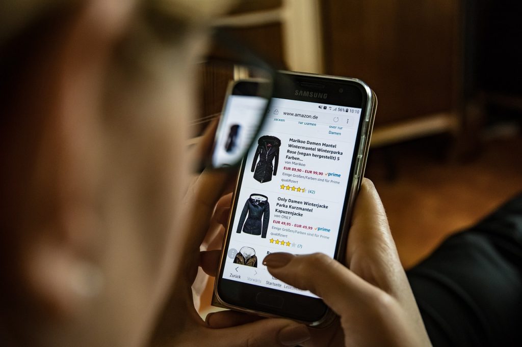 Person browsing online shopping options on a smartphone, representing a drop shipping side hustle